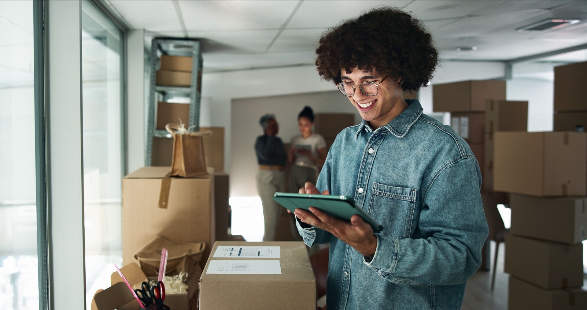 Happy man, tablet or typing in business for logistics, startup review or package checklist at box. Entrepreneur, tech or smile in warehouse for inventory management, supply chain or app for delivery